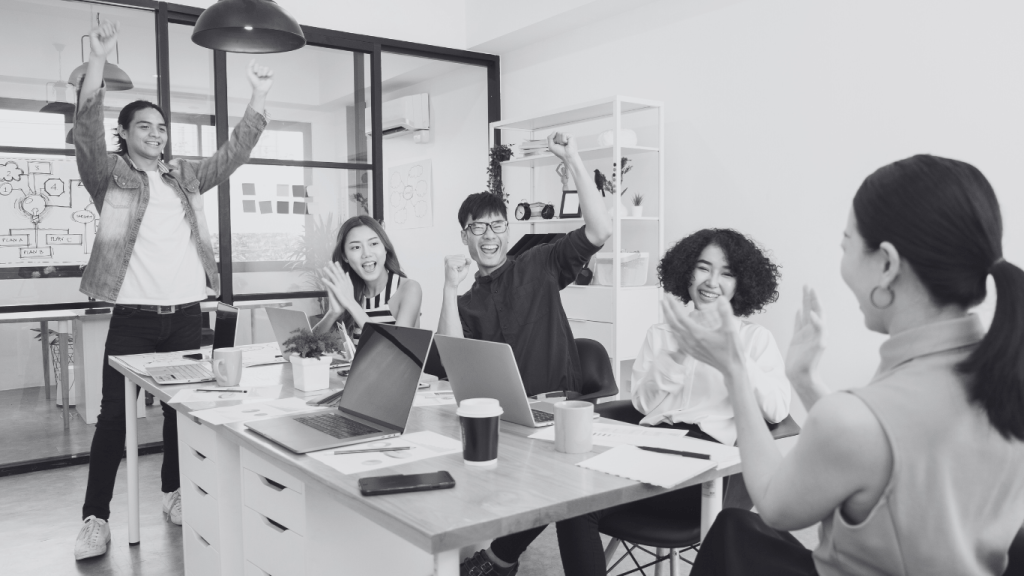 Happy people liaising and talking about Bastian services happy in office with different hiring managers in the supply chain & tech space